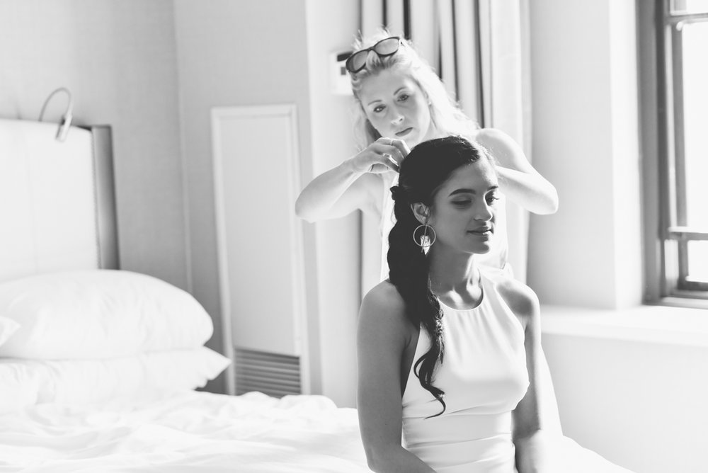 black and white photo of bride getting her hair done