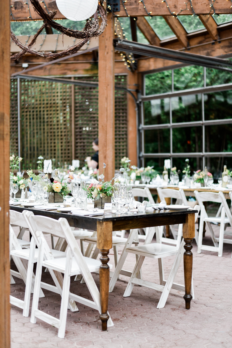 Rustic farm tables with white chairs wedding decor