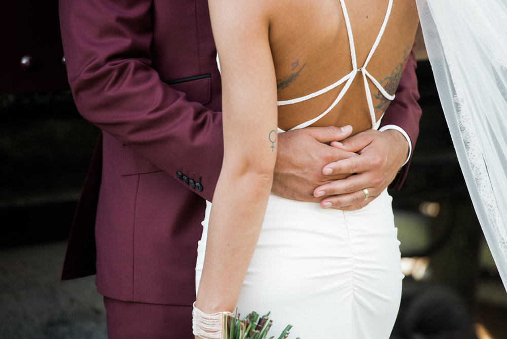 hands wrapping around waist wedding photo