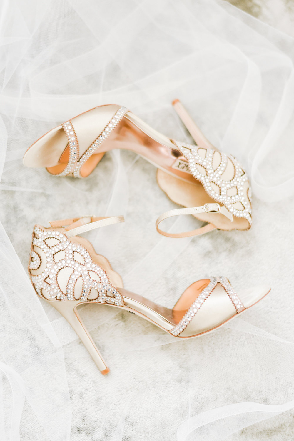 Bridal shoes laying on veil