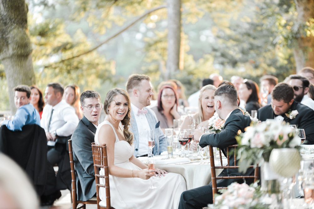 Laughing guests in candid outdoor wedding reception