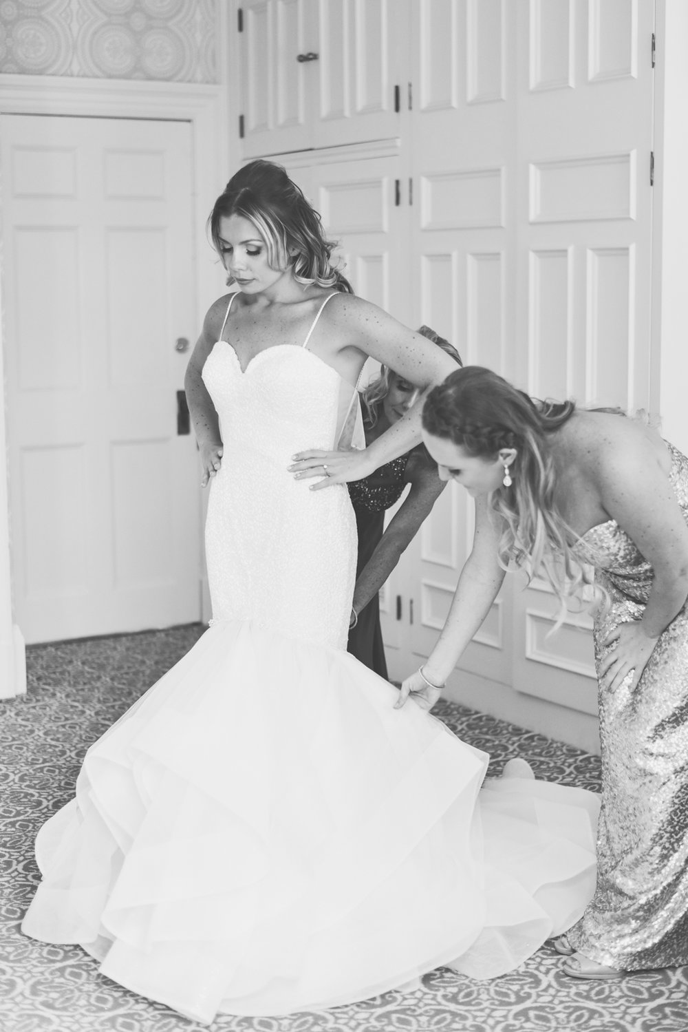 Bride putting on Pnina Tornai gown