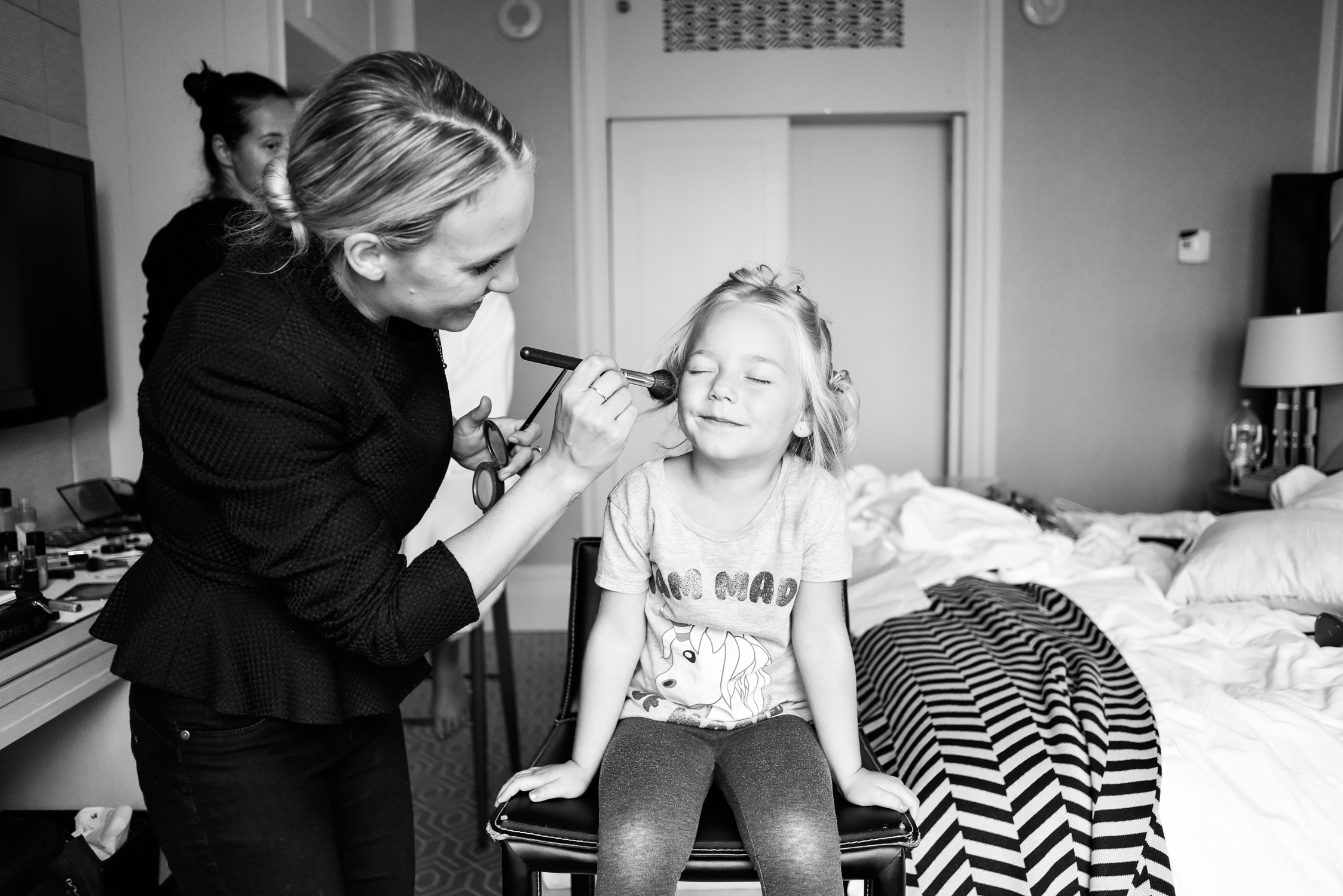 Little girl getting makeup done