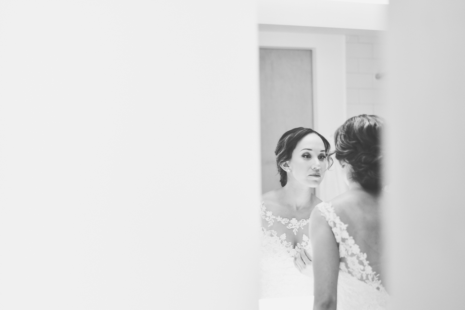 Bride looking in mirror wedding photo