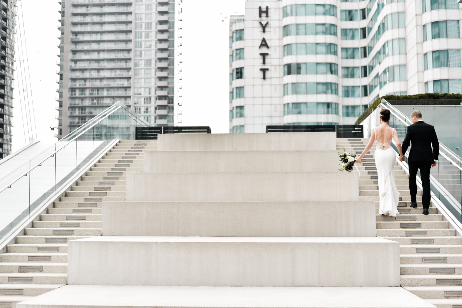 Couple walks up the steps of Malaparte in this downtown Toronto wedding