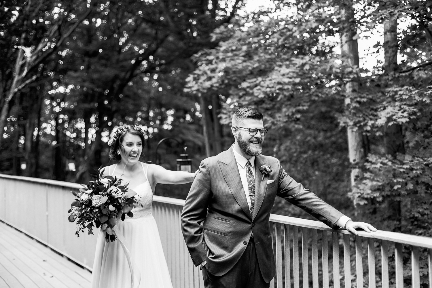 Black and white photo of a couple sharing a first look on the balcony on the Kortright Centre