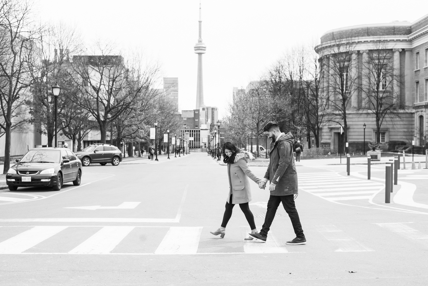 Couple in front of Convocation Hall with the CN tower in the background