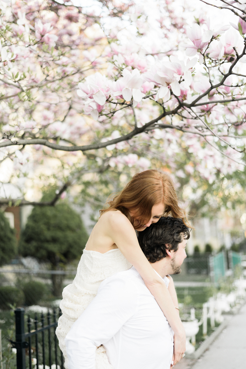 Engagement photo of a couple under a magnolia tree