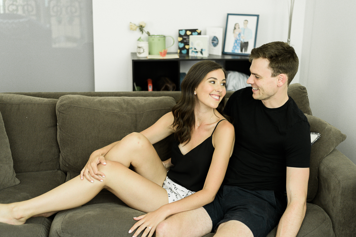 Couple lounging for their natural, at home engagement session
