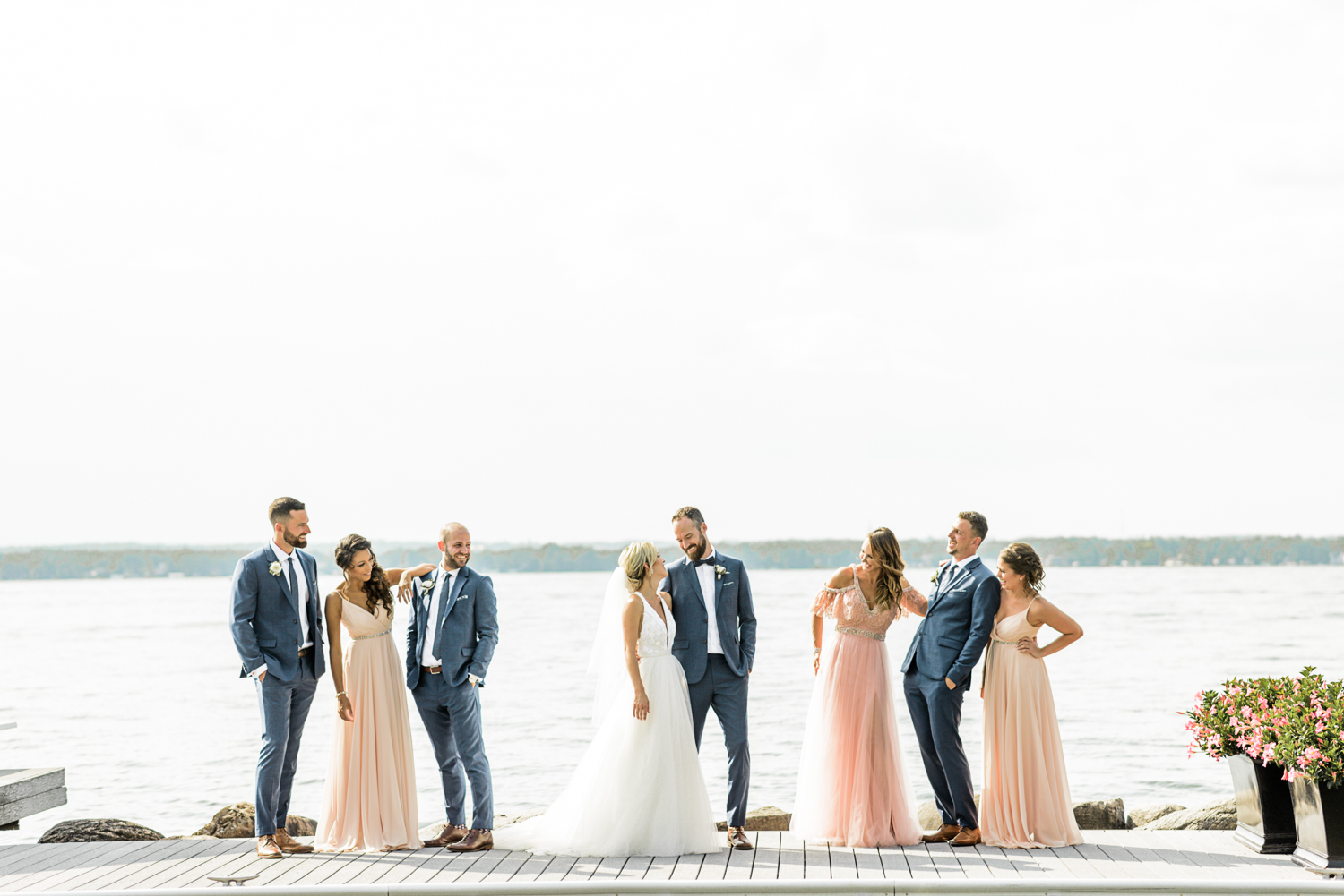 Bridal party on a dock overlooking a lake