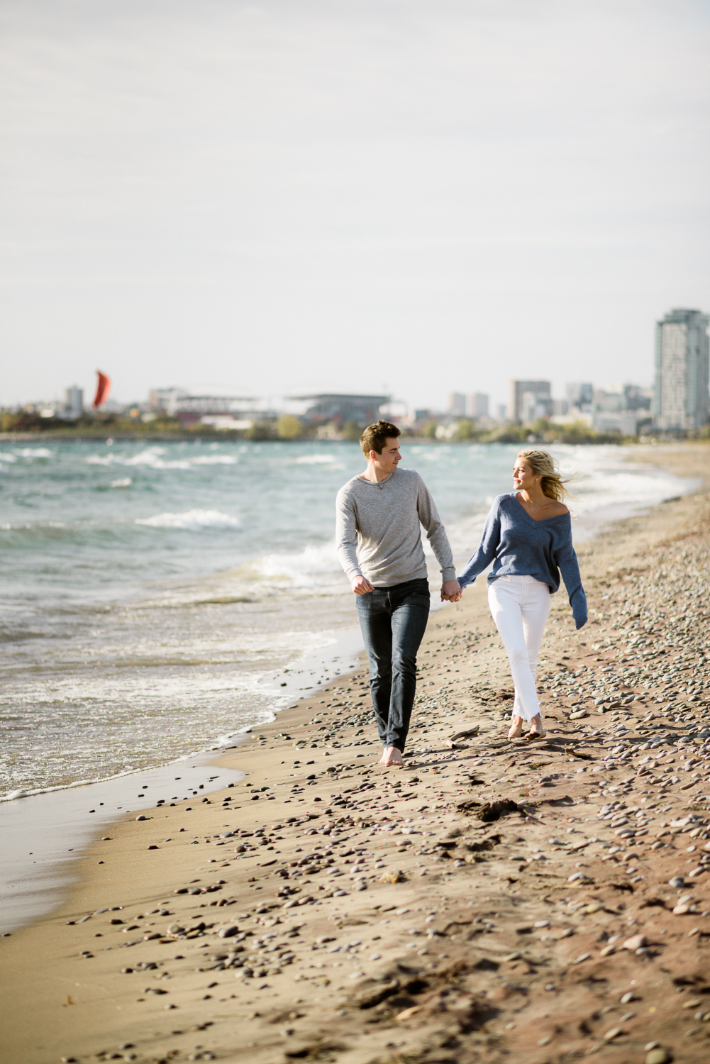 Couple walks on the windy beach
