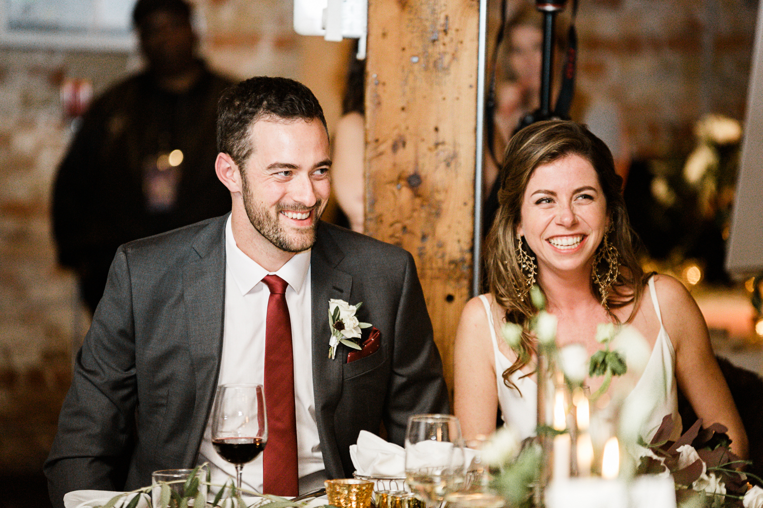 Couple laughs at the reception of their archeo wedding