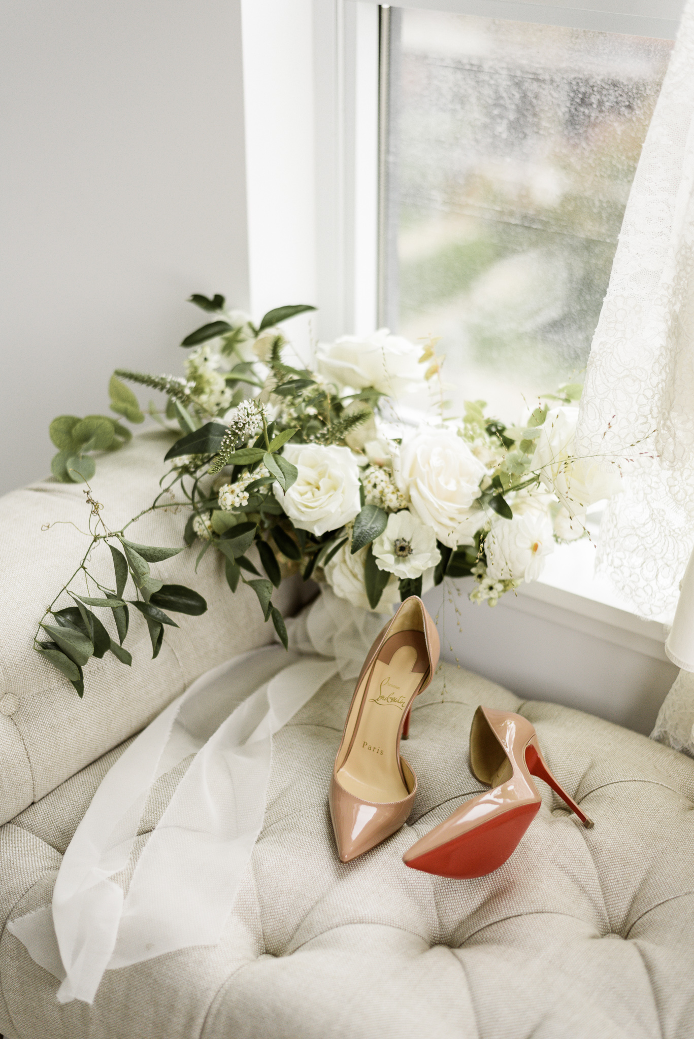 Louboutin wedding shoes with bridal bouquet detail shot