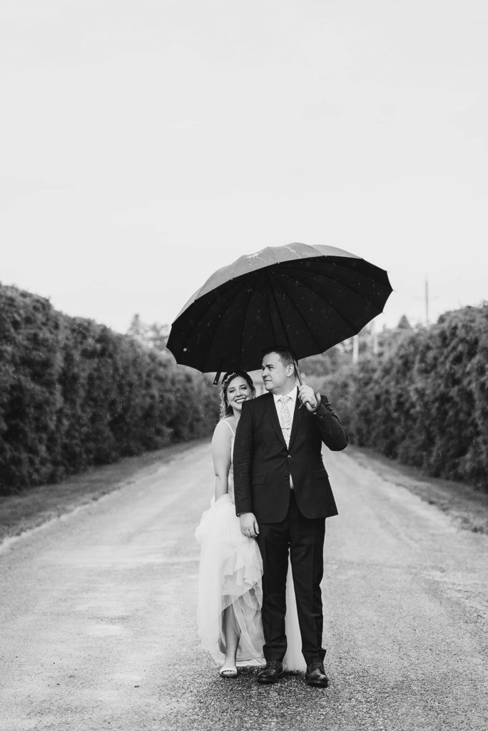 Black and white rainy wedding photo.