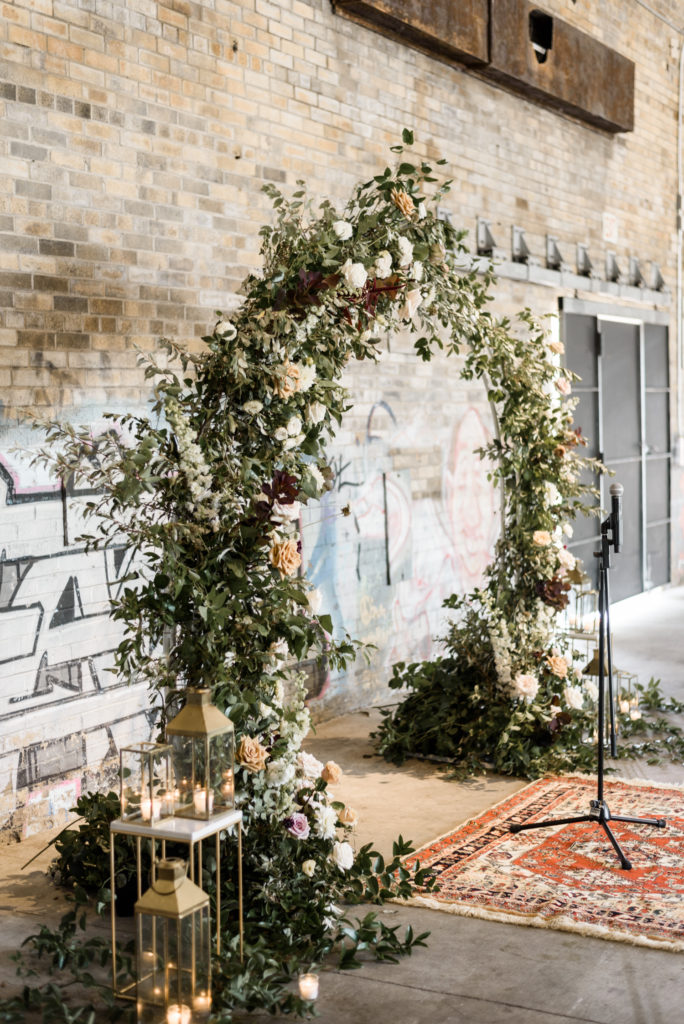 Flower arch at brickworks wedding indoors