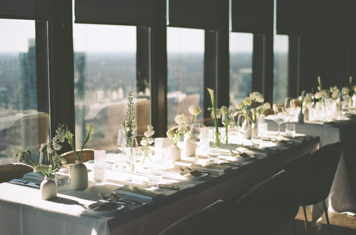 canoe restaurant wedding reception with beautiful white and green flowers